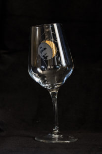 Wine glass with the moon and a blade of grass, bent